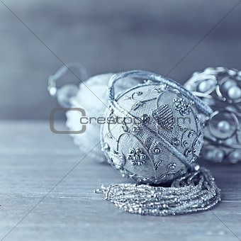 Silver christmas tree ornaments on wooden background