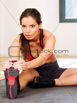 Gorgeous woman stretching in the gym