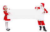 Kids dressed as santa offering you a copy space on banner