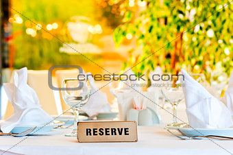 beautifully laid for supper table with a sign reserved