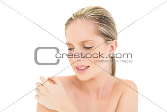 Irritated fresh blonde woman looking at her shoulder