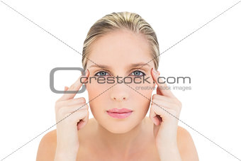 Thinking fresh blonde woman touching her temples