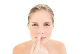 Peaceful fresh blonde woman touching her nose