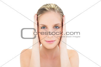 Content fresh blonde woman covering her ears