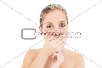 Pretty fresh blonde woman covering her mouth