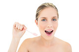Content fresh blonde woman holding a toothbrush