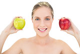 Pleased fresh blonde woman holding two apples