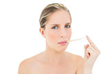 Stern fresh blonde woman using a thermometer