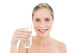 Amused fresh blonde woman holding a glass of water