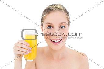 Charming fresh blonde woman holding a glass of orange juice