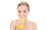 Natural fresh blonde woman drinking orange juice