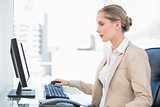 Peaceful blonde businesswoman working on computer