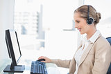 Smiling blonde call centre agent working