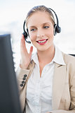 Content blonde call centre agent interacting with customer