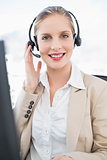 Smiling blonde call centre agent interacting with customer