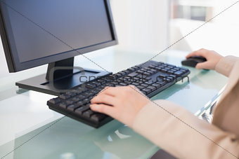 Close up on businesswoman working on computer