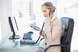 Side view of blonde businesswoman on the phone