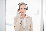 Smiling blonde call centre agent standing