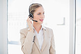 Cheerful blonde call centre agent standing