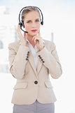 Thoughtful blonde call centre agent standing