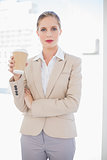 Peaceful blonde businesswoman holding coffee
