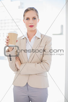 Peaceful blonde businesswoman holding coffee