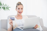 Surprised fresh model shopping online using laptop