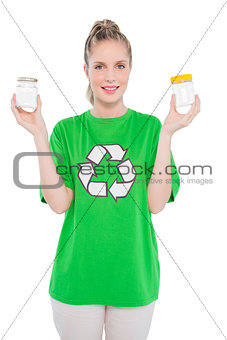 Smiling environmental activist wearing recycling tshirt holding jars