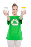 Happy environmental activist wearing recycling tshirt holding jars