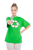 Peaceful activist wearing recycling tshirt holding light bulb