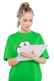 Focused blonde activist writing on clipboard