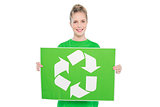 Smiling blonde environmental activist holding recycling sign