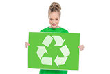 Content blonde environmental activist holding recycling sign