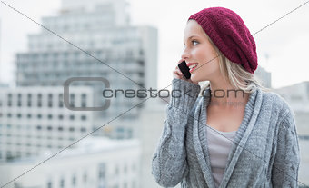 Happy pretty blonde on the phone outdoors