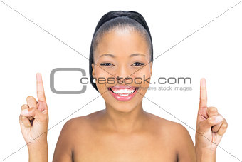 Attractive woman pointing upwards