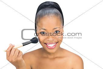 Woman using a makeup brush