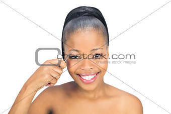 Smiling woman using tweezers