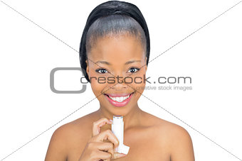 Happy woman holding asthma inhaler