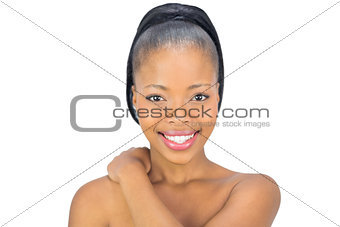Smiling woman touching her neck
