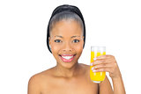 Smiling woman holding glass orange juice
