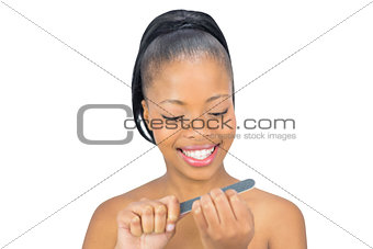 Happy woman using nail file