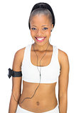 Cheerful attractive woman in sportswear listening to music