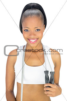 Attractive fit woman in sportswear holding jump rope