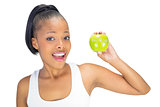 Happy fit woman holding green apple