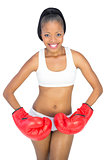 Fit woman with red boxing gloves posing