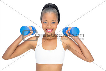 Sporty woman working out with dumbbells