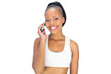 Happy woman in sportswear talking on phone