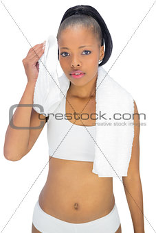 Sporty woman in sportswear using towel