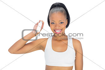 Smiling woman holding asthma inhaler