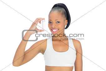 Pretty smiling model holding asthma inhaler